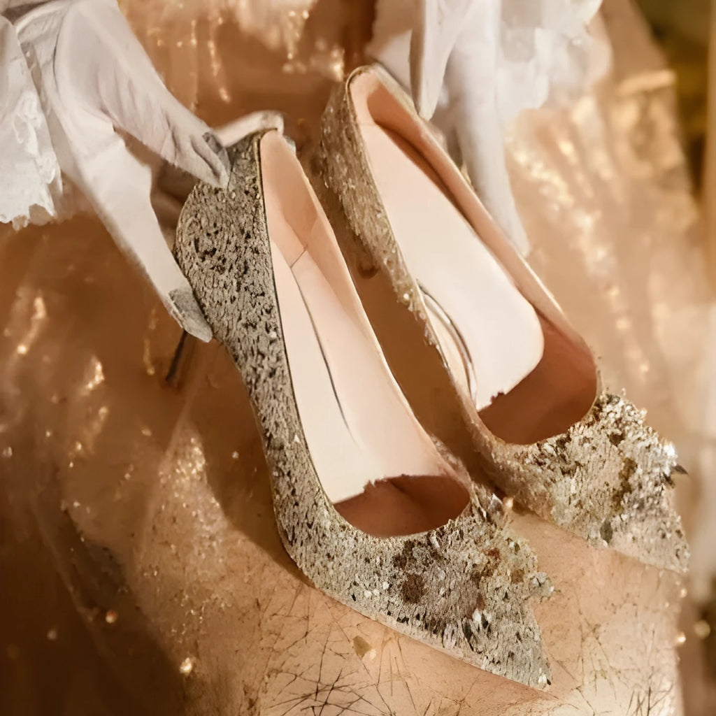 Champagne-coloured women's bridal shoes with rhinestone details, pointed toe, and a fine heel.