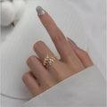 A leaf-shaped geometric copper ring with an electroplated silver or gold finish for women.