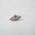 Close-up of geometric spider web patterned metal stud earrings in a gold electroplated finish.