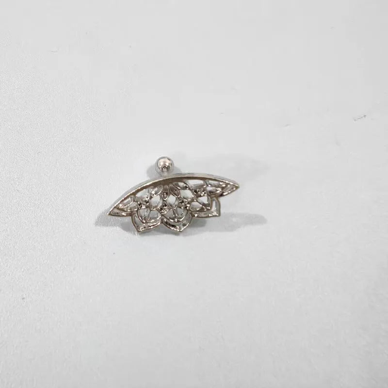 Close-up of geometric spider web patterned metal stud earrings in a gold electroplated finish.