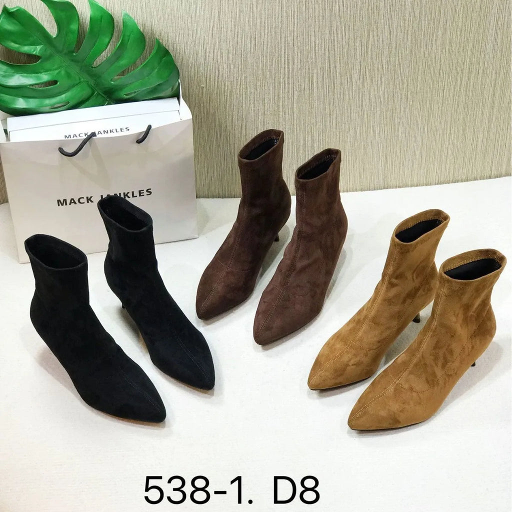 Black pointed toe women's ankle boot with high stiletto heel and mid-calf shaft on a plain background.