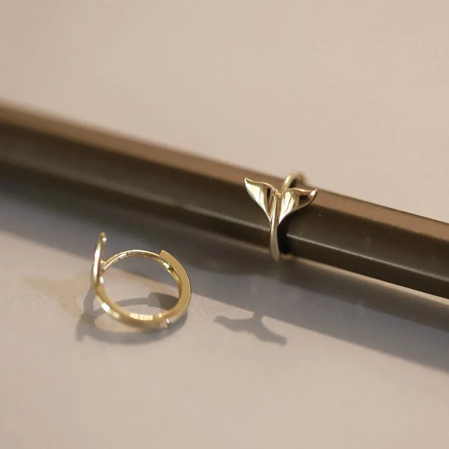 S925 sterling silver fishtail drop earrings in gold colour, showing smooth design and size.