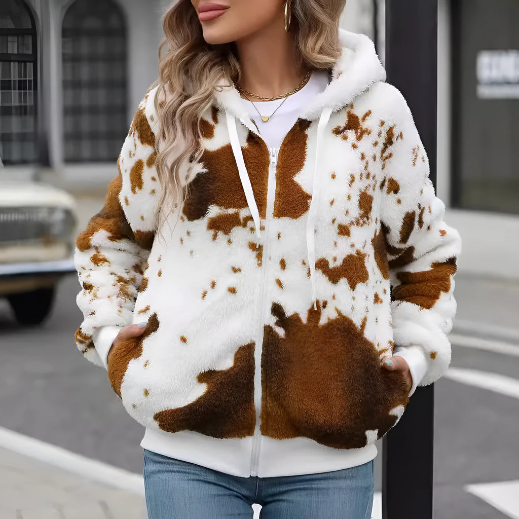 Yellow brown cow animal print hooded cardigan jacket with full zipper on a model.