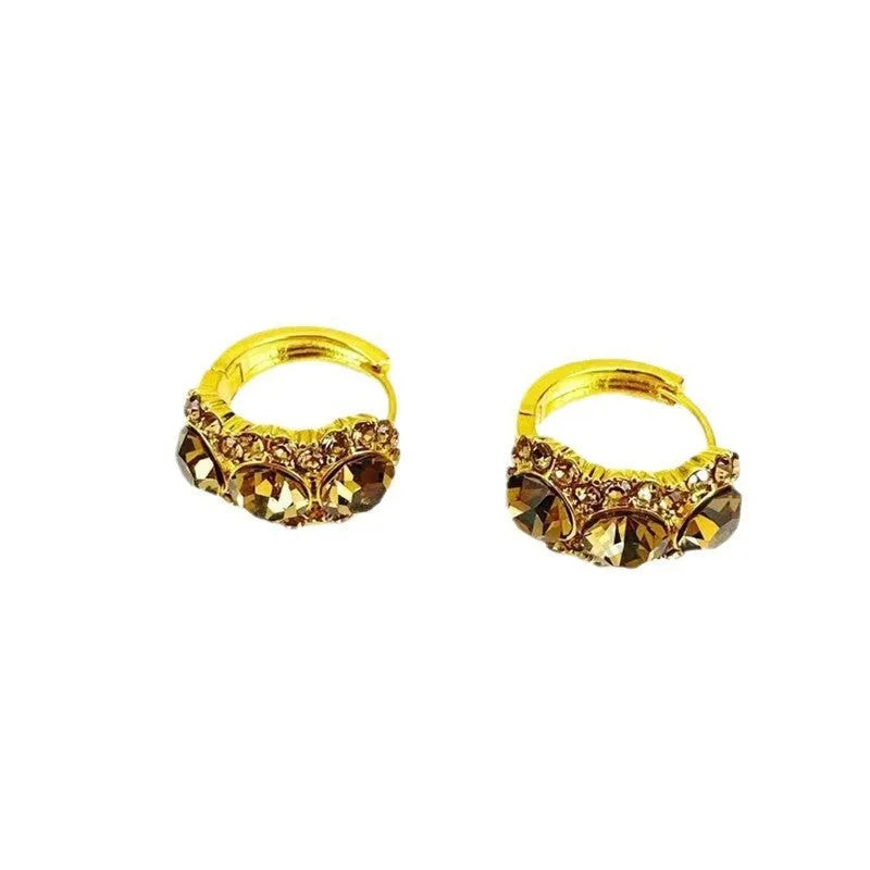 Gold metal hoop earrings with diamond surface treatment and brown zircon stones