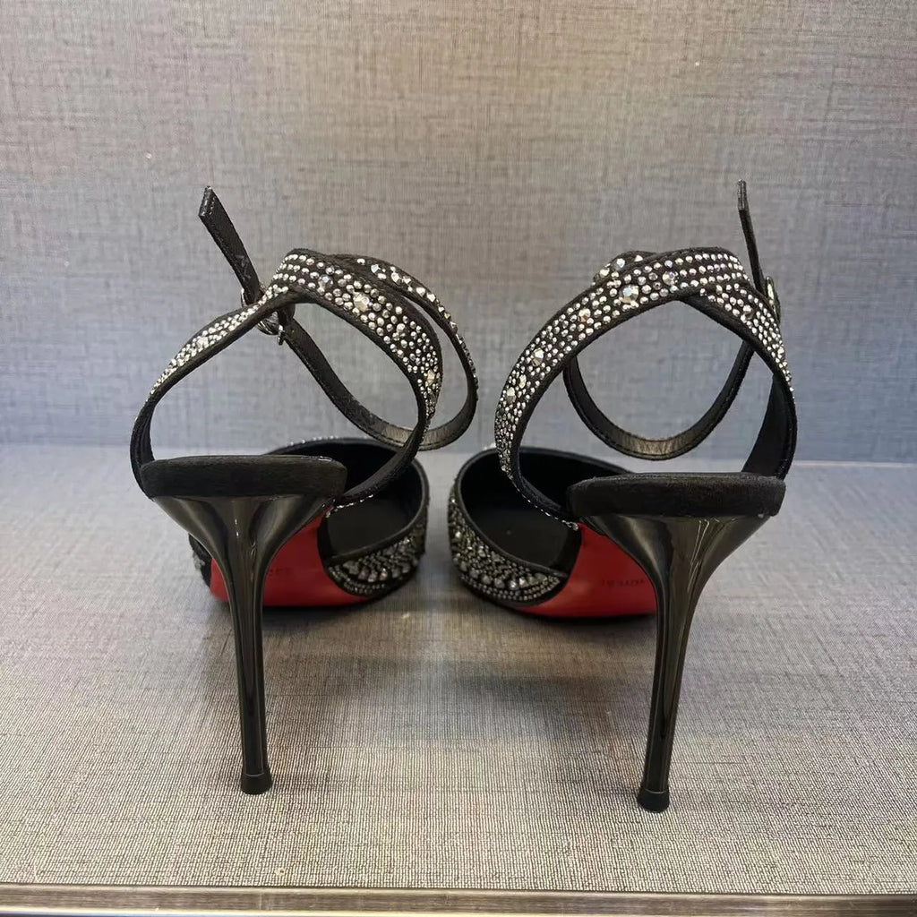 Women's black hollow stiletto heel pumps with a red sole and pointed toe.