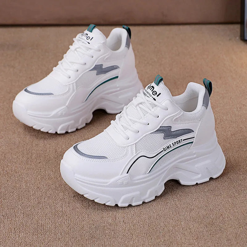 White women's low-top sports trainers with a front lace-up and cross-strap detail.