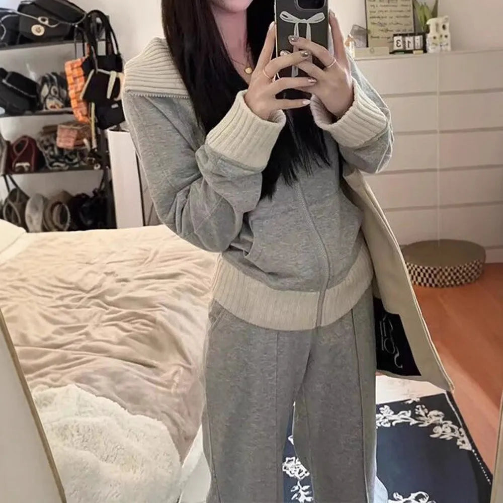Women's light gray polyester two-piece set consisting of a pocket coat and wide leg trousers, shown flat lay view.