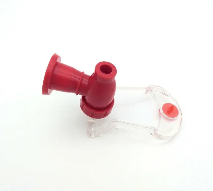 Red plastic Magic Tap soda drink dispenser for 2-litre bottles on a kitchen counter.