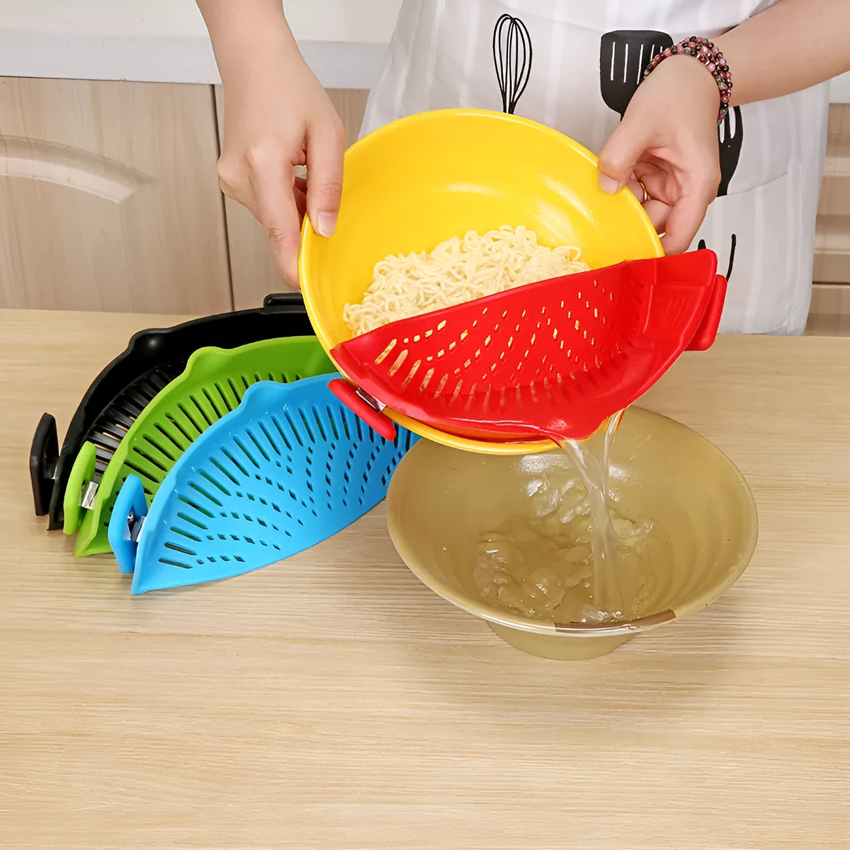 Silicone clip-on kitchen strainer with stainless steel mesh attached to cooking pot