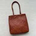 Handmade woven brown leather tote bag with three-dimensional pockets and vintage finish