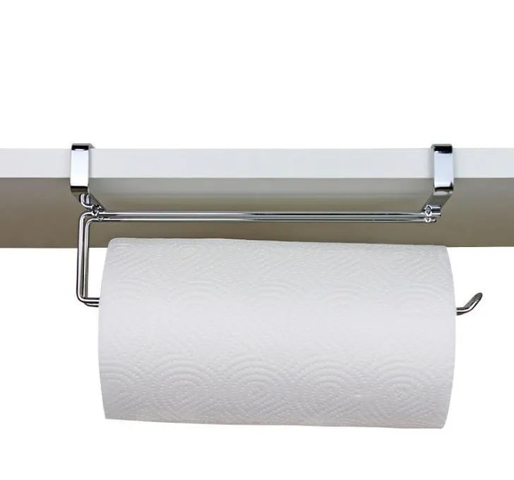 Silver stainless steel paper towel rack hanging on a kitchen cabinet door