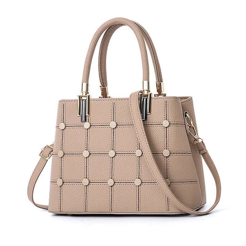 Women's handbag with rivet detailing in dark green, internal multi-pocket storage, PU outer and polyester lining