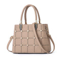 Women's handbag with rivet detailing in dark green, internal multi-pocket storage, PU outer and polyester lining