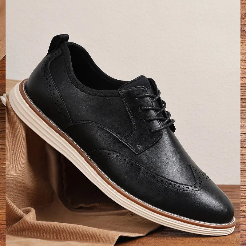 Men's black slip-on business casual shoes with round toe and carved detail on a white background.