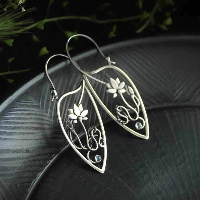 Silver lotus vine floral earrings with geometric elements and rhinestone accents