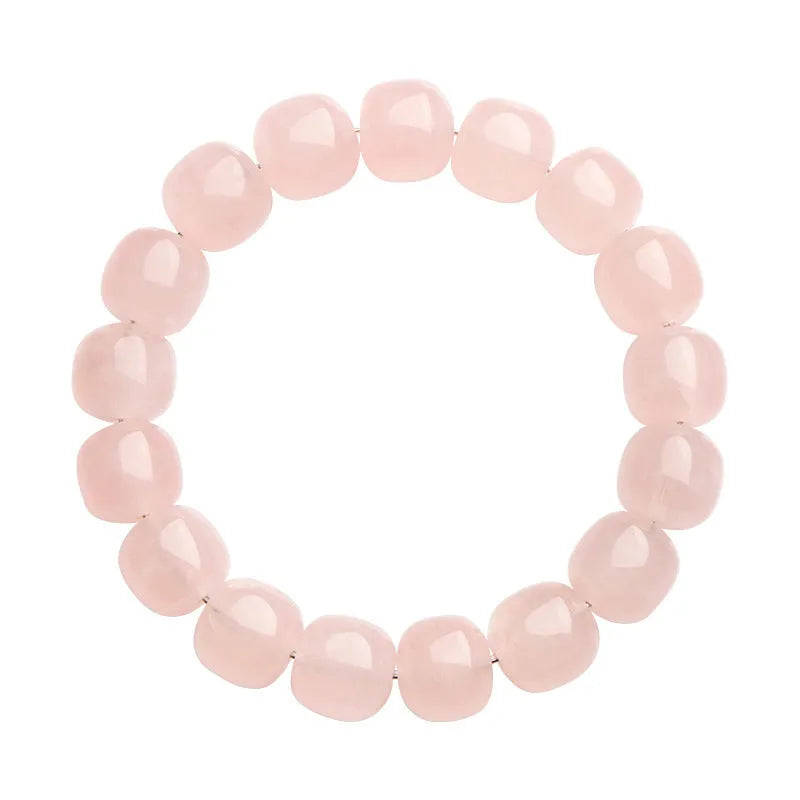 Pink barrel crystal bead bracelet with geometric design on wrist.