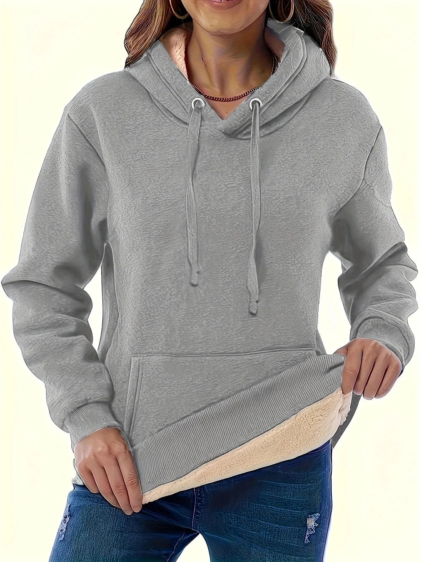 Women's black loose fit hooded sweater with pockets and long sleeves laid flat.