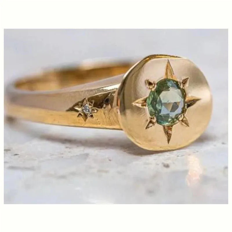Golden star-shaped ring with oval zircon detailing and adjustable opening