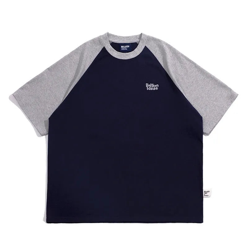 Blue casual men's t-shirt with raglan sleeves on a hanger, showing loose fit.