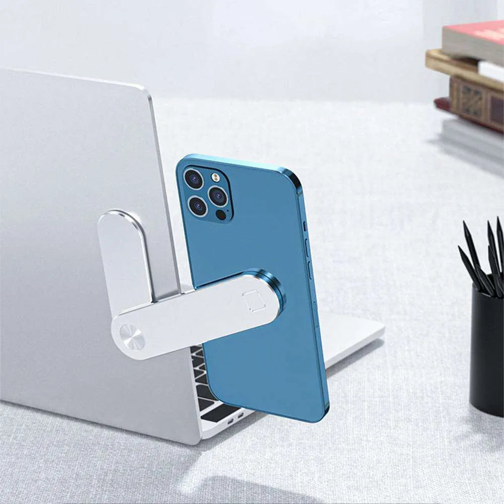 Black aluminium magnetic phone holder mounted on side of laptop screen with smartphone attached.
