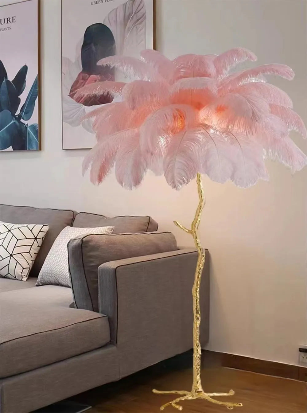 Tall decorative floor lamp with many white resin feathers and a dark base on a wooden floor.