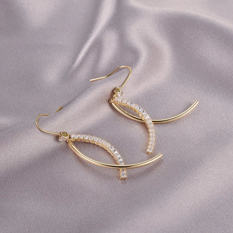 Pair of gold irregular geometric copper earrings on display