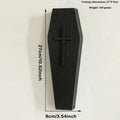 Black wooden cross-shaped wall shelf with space for holding small plants or decorative items.