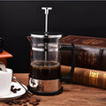 350ml manual French press coffee maker with glass carafe and stainless steel plunger, measuring 10cm by 8cm by 17cm.