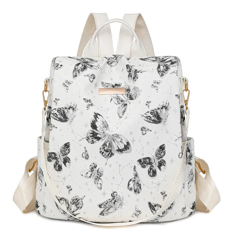 Butterfly print backpack with sewing line detail shown in multiple colour options
