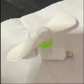 White mobile phone mini fan attached to smartphone showing plastic blades and rotary switch