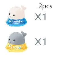 White and blue whale bath toy spraying water with LED lights illuminated