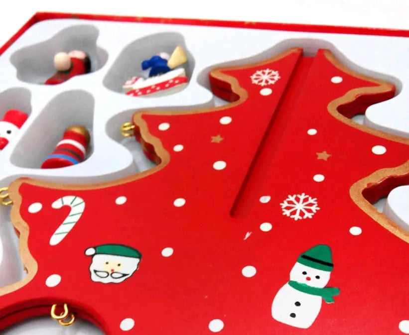 Hand painted wooden Christmas tree decorations in red and green colours on desktop