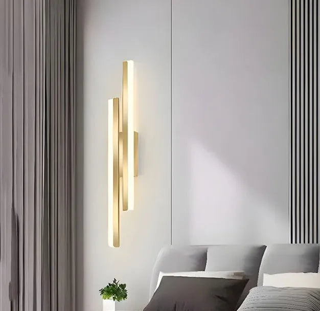 Gold finished double line wall lamp with tri-colour lighting for hotel stairs and modern interiors