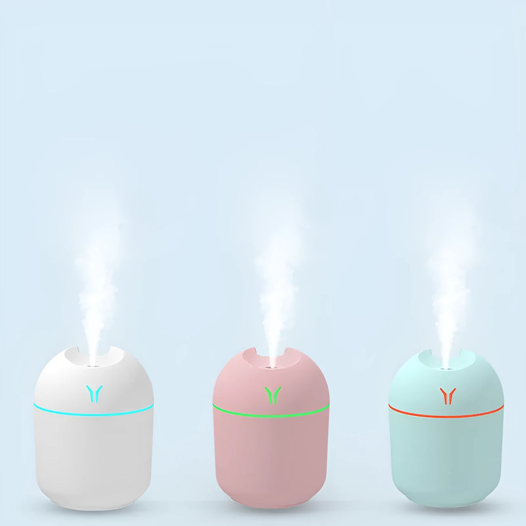 Round desktop humidifier with USB cable in ivory white colour showing mist output