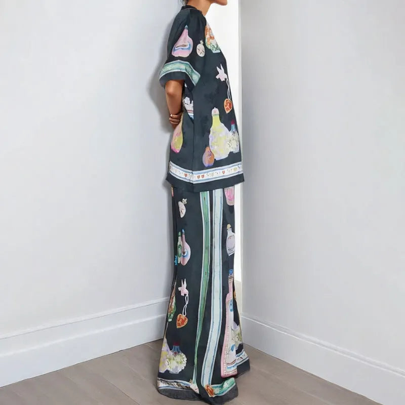 Black women's casual set with cartoon pattern, featuring a short sleeve cardigan and matching trousers.