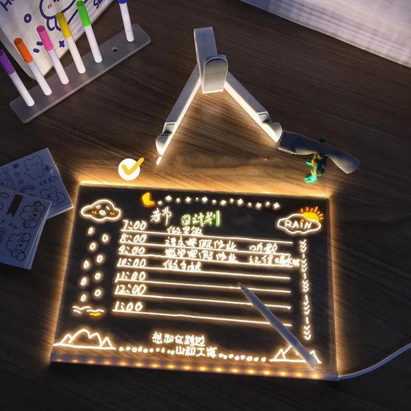 Acrylic DIY note board LED night light with USB cable, bracket, and colourful pens on a desk
