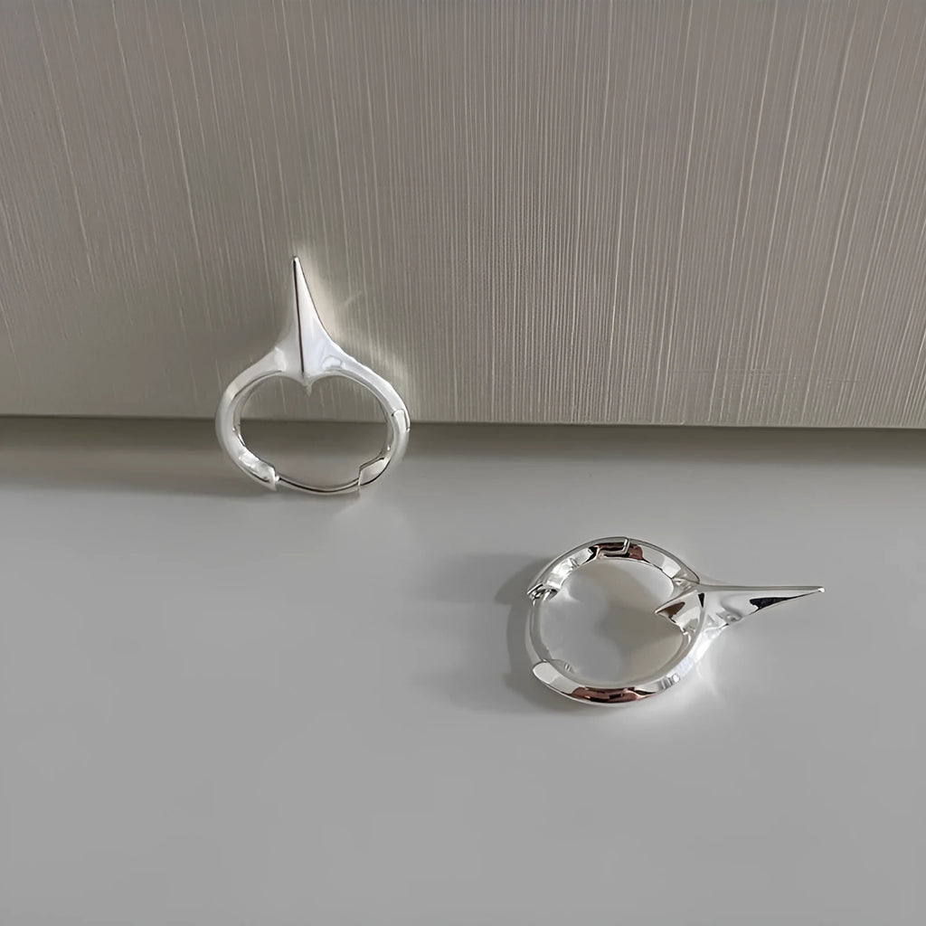 Women's platinum-coloured geometric star ear clips with a white gold plated finish.