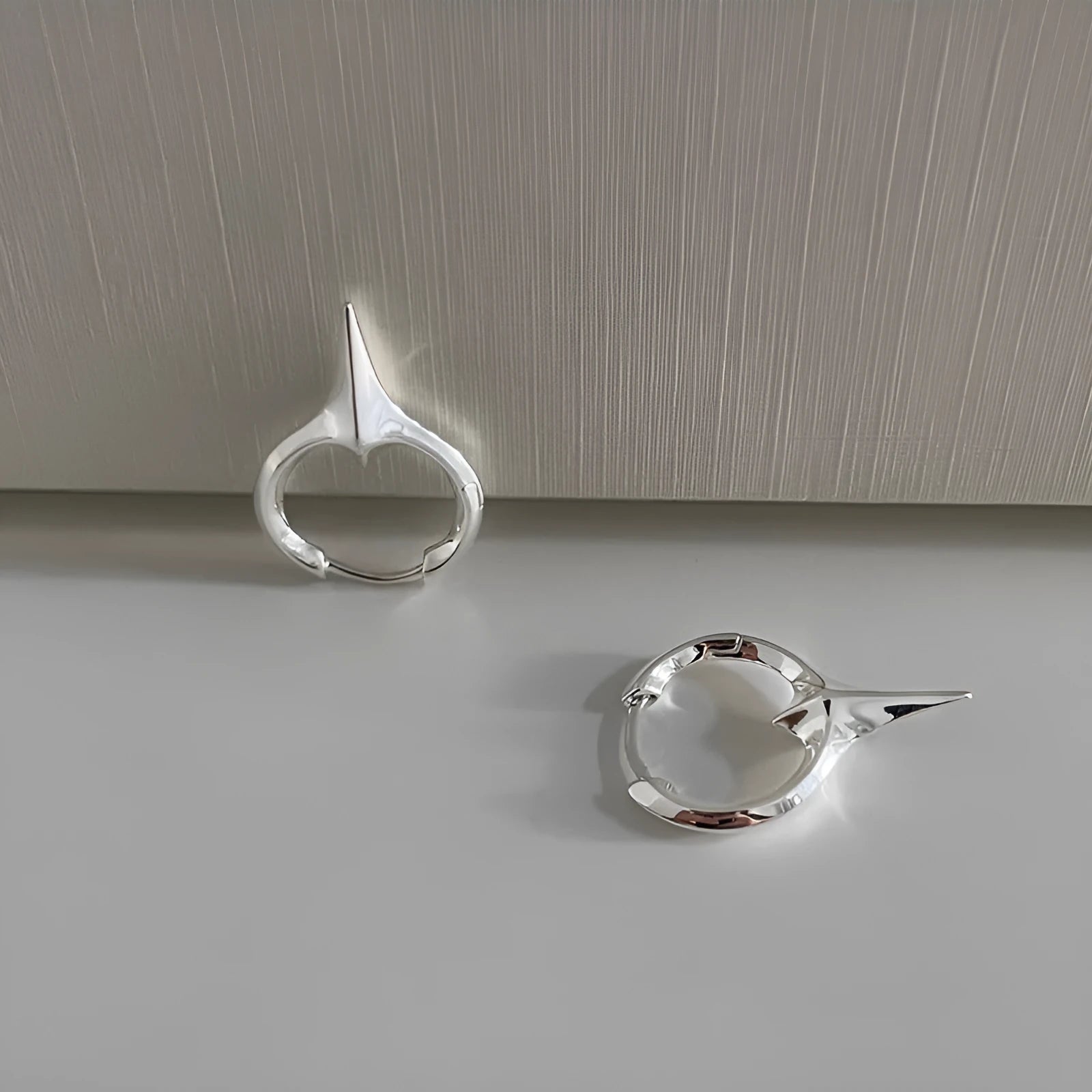 Women's platinum-coloured geometric star ear clips with a white gold plated finish.