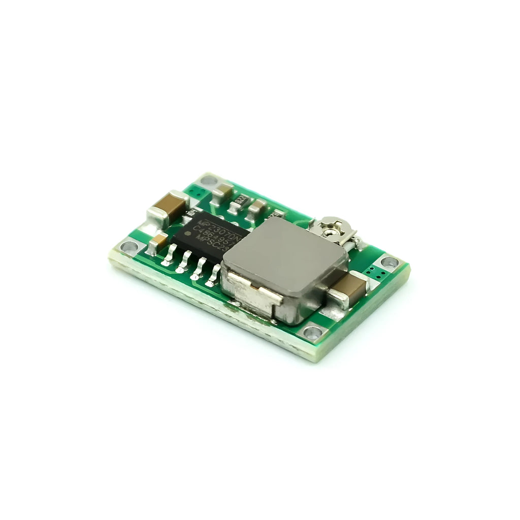 Mini-360 green DC-DC buck converter step down power module on white background