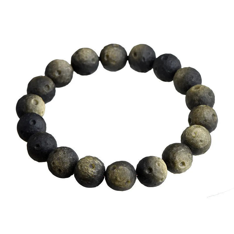 Natural obsidian crater ball bracelet in silver stone or gold finish, showing textured bead detail.