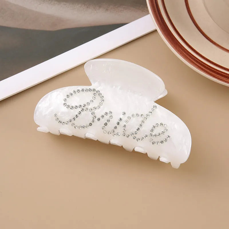 Pink and white 10cm acrylic shower hair clip with spot drill and letter decoration.