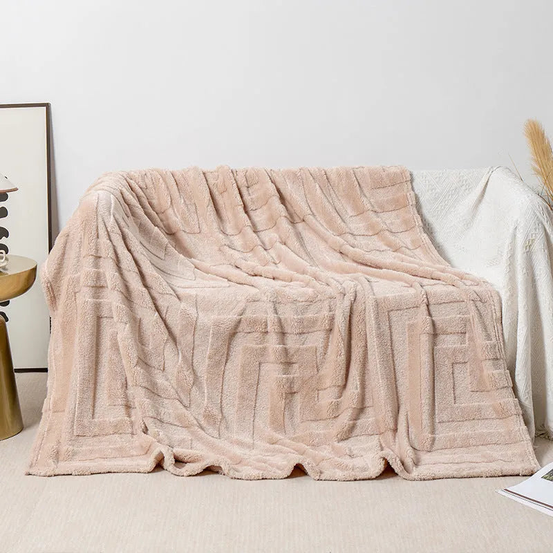Thick square coral fleece flannel blanket with solid colour and floral pattern, folded to show texture.