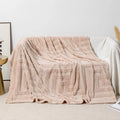 Thick square coral fleece flannel blanket with solid colour and floral pattern, folded to show texture.
