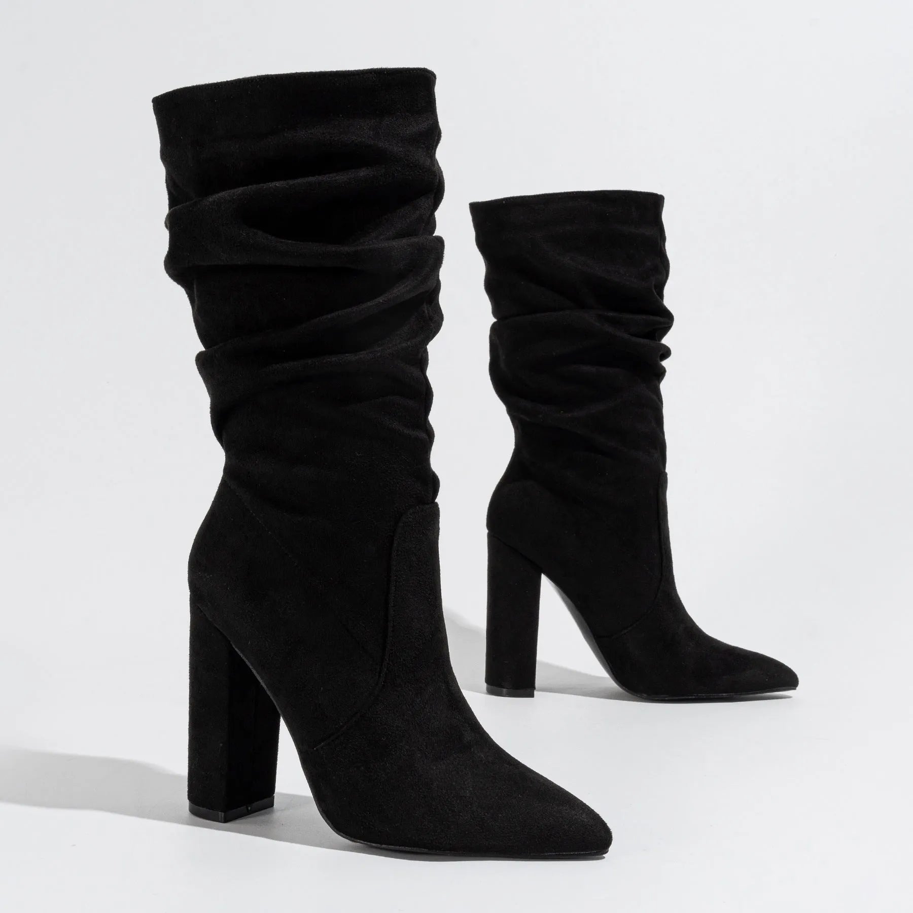Women's black suede boots with chunky high heel and pointed toe design