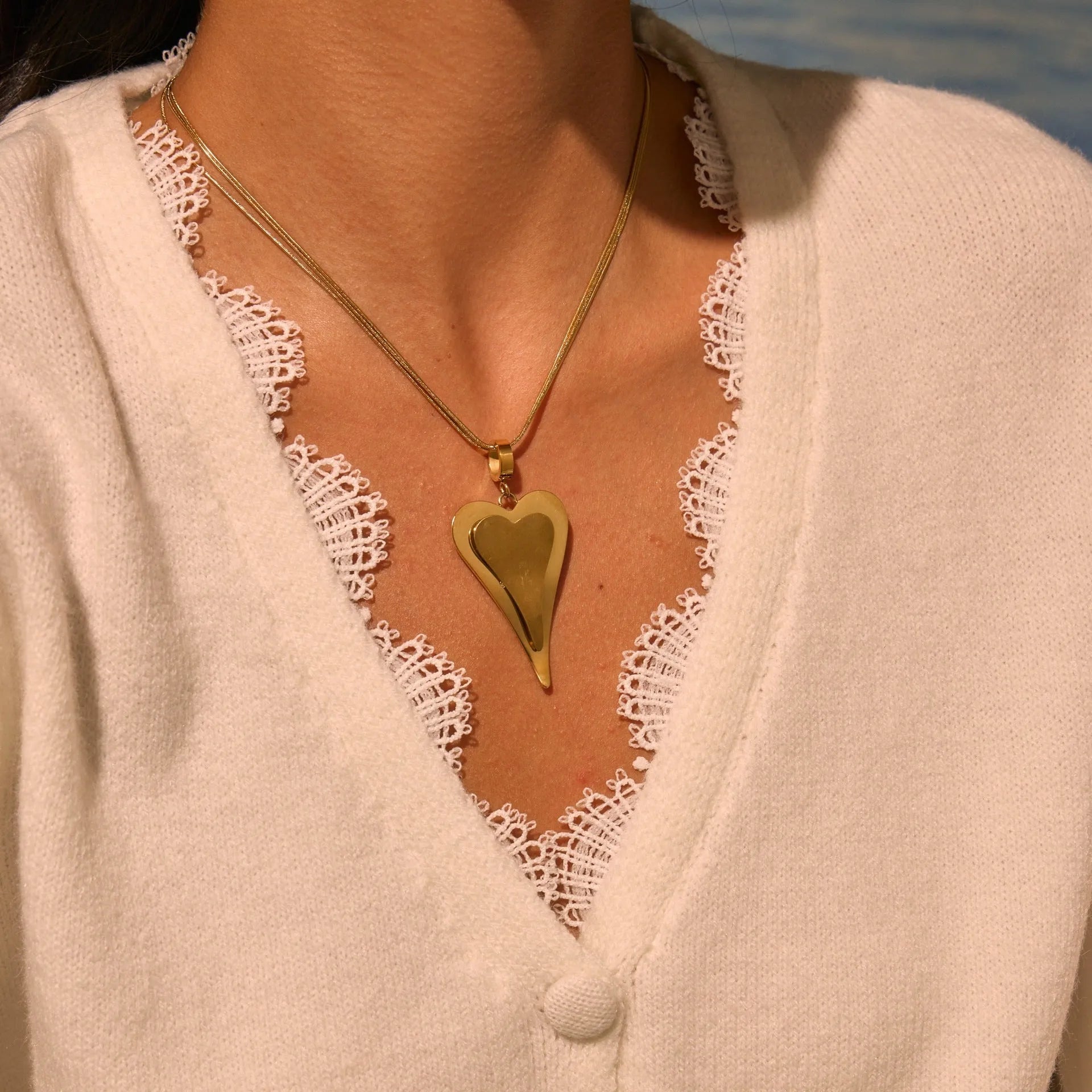 Stainless steel women's necklace with double heart geometric pendant on a snake bones chain.