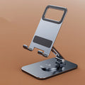 Folding aluminium alloy mobile phone stand in silver on a desktop showing rotary mechanism