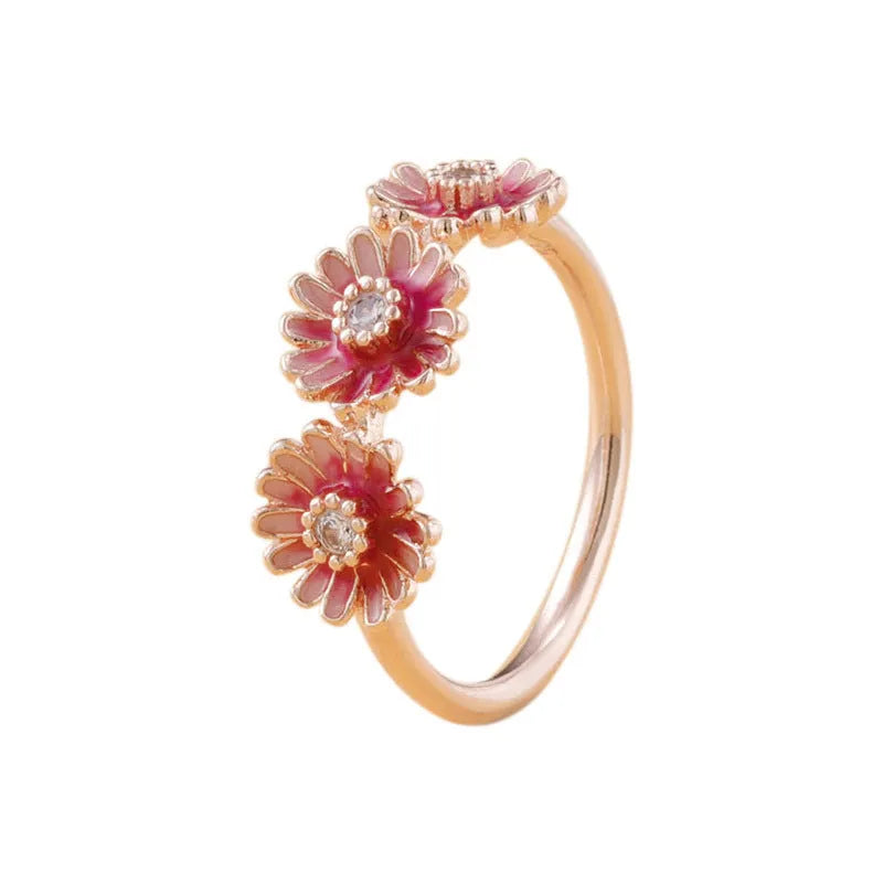 Three pink daisy rings with pink gemstone inlay in 925 sterling silver