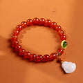 Red agate bracelet with amber accents and geometric Maitreya Buddha charm