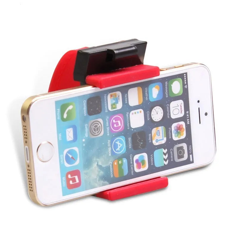 Black steering wheel phone holder clip mounted on car steering wheel holding smartphone