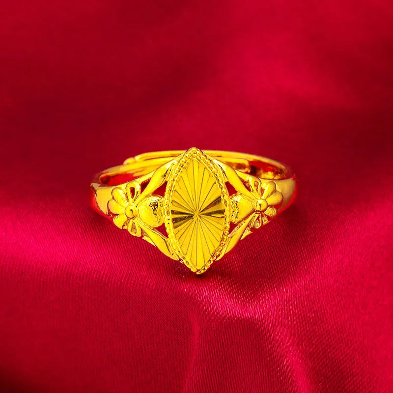 Gold open diamond flower ring with geometric floral pattern and textured brass construction